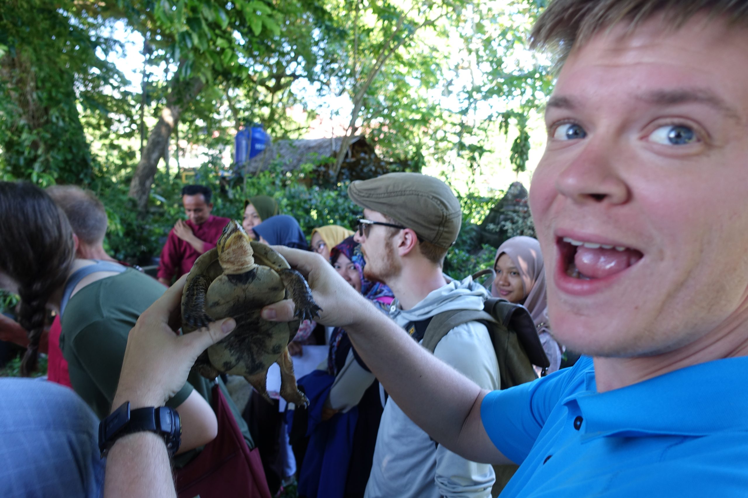 John Shields holding a turtle at the Bengkulu University Turtle Preserve, GES Field School 2017, Bengkulu, Indonesia